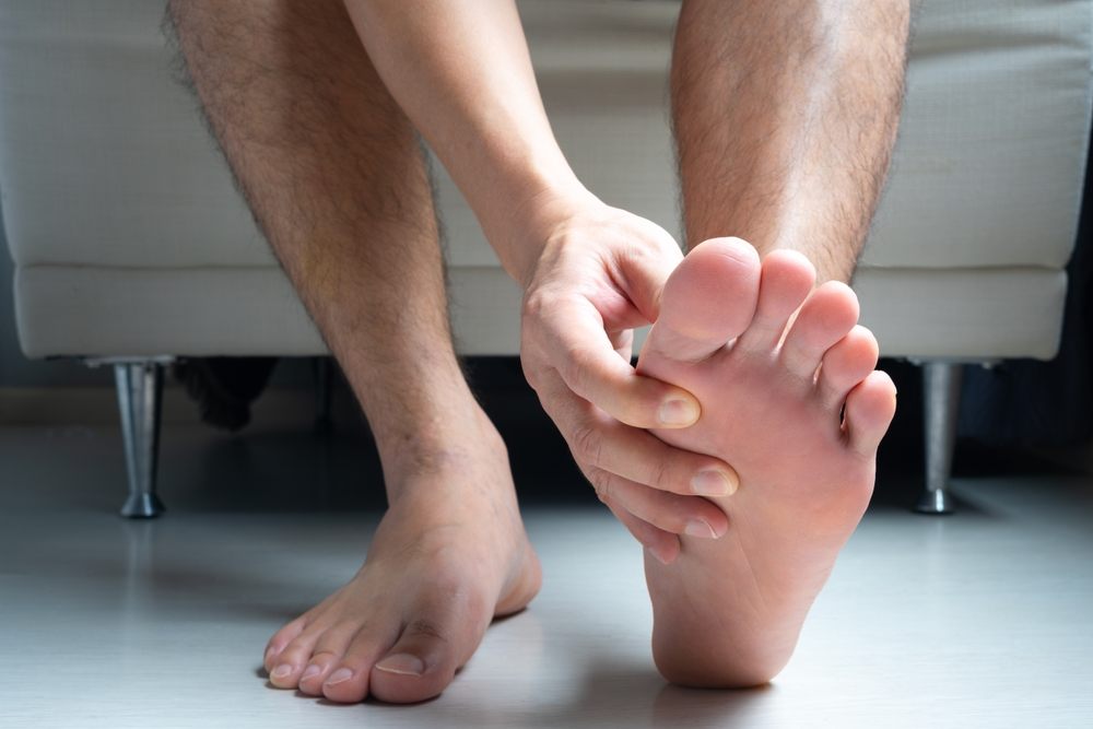 Custom Orthotics Help with Plantar Fasciitis. Man, foot pain and cramps in legs and ankles from Plantar Fasciitis disease Be relieved the pain with the soles of his feet.