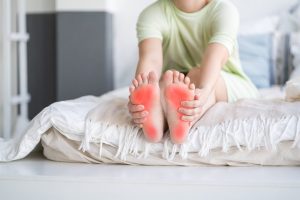 Can Orthotics Help Treat Plantar Fasciitis and Bunions? Plantar fasciitis. Joint diseases, plantar fasciitis, a woman's leg hurts, pain in the foot, massage of female feet at home, health problems concept.