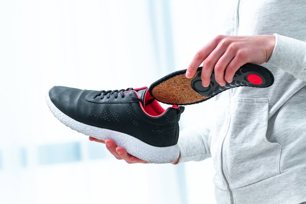 How Orthopedic Shoes Support Foot Health Beyond Just Comfort. Orthopedic insoles for sports shoes. Treatment and prevention of flat feet and orthopedic foot diseases. Foot care, foot comfort. Health care, wearing comfortable shoes.