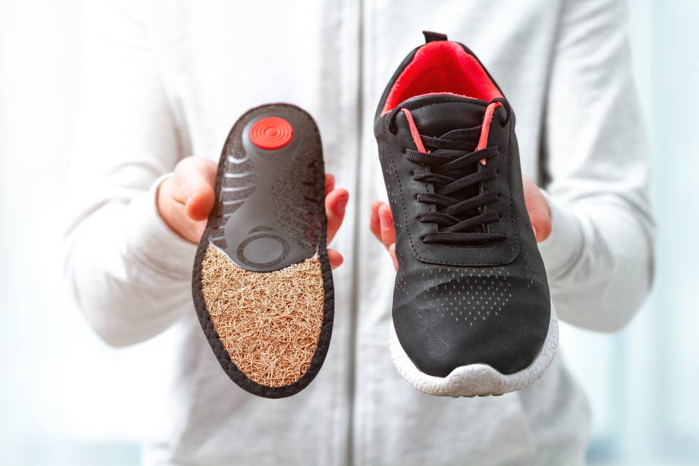 How Orthopedic Shoes Support Foot Health Beyond Just Comfort. Orthopedic insoles for sports shoes. Treatment and prevention of flatfeet and orthopedic foot diseases. Foot care, foot comfort. Health care, wearing comfortable shoes.